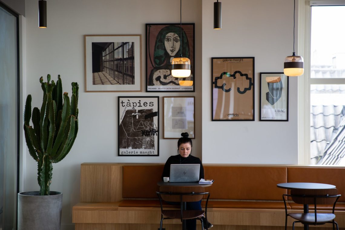 Lady in a cafe formulating how to write a follow-up email