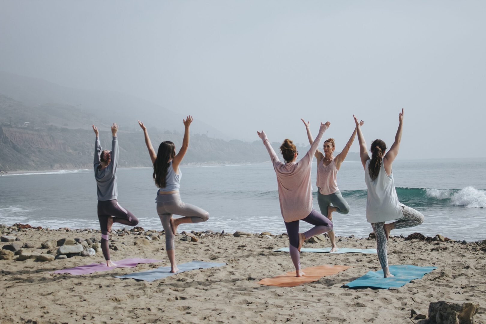 Yoga on the beach for workplace wellness