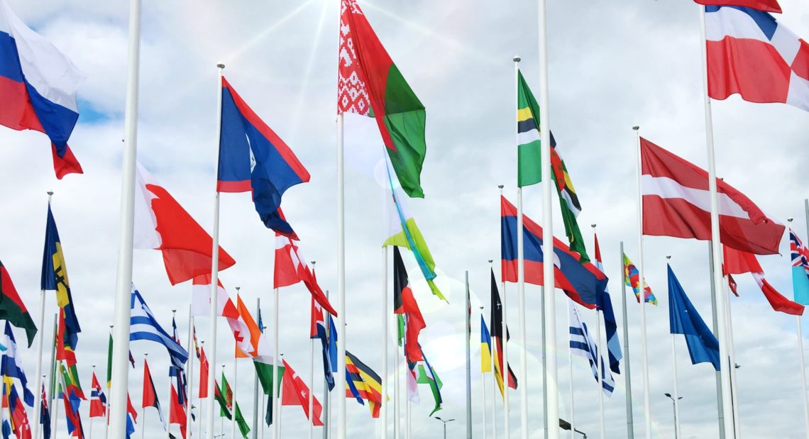 Many flags representing how recruiting international employees is beneficial 