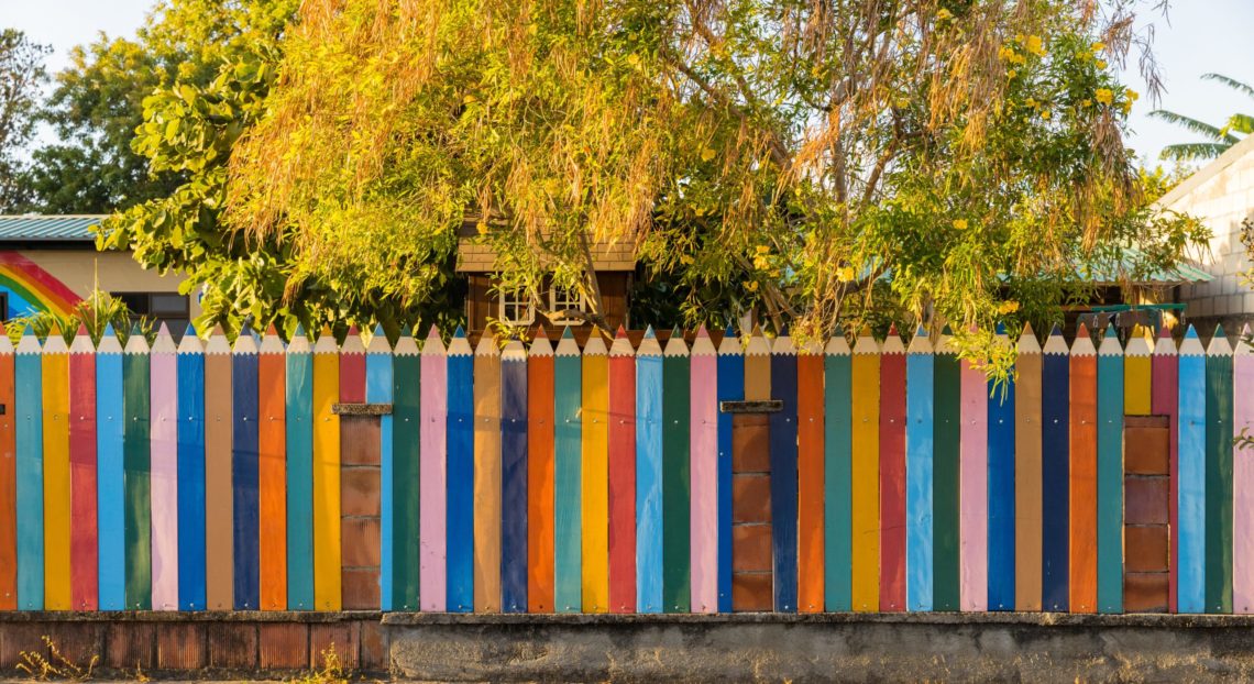 A colourful fence representing neuroinclusivity