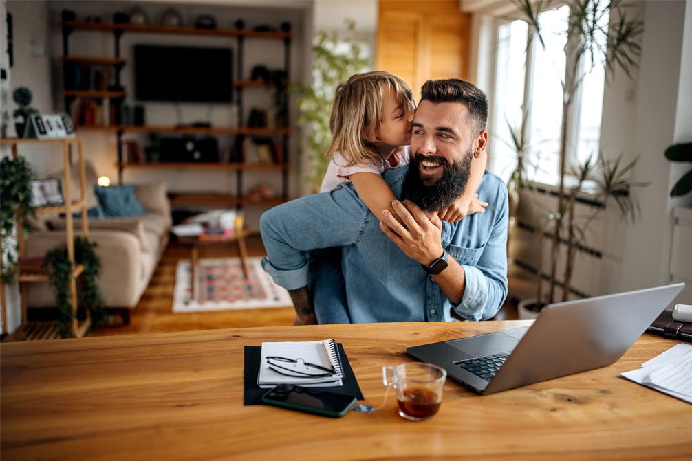 Dad working from home with daughter 