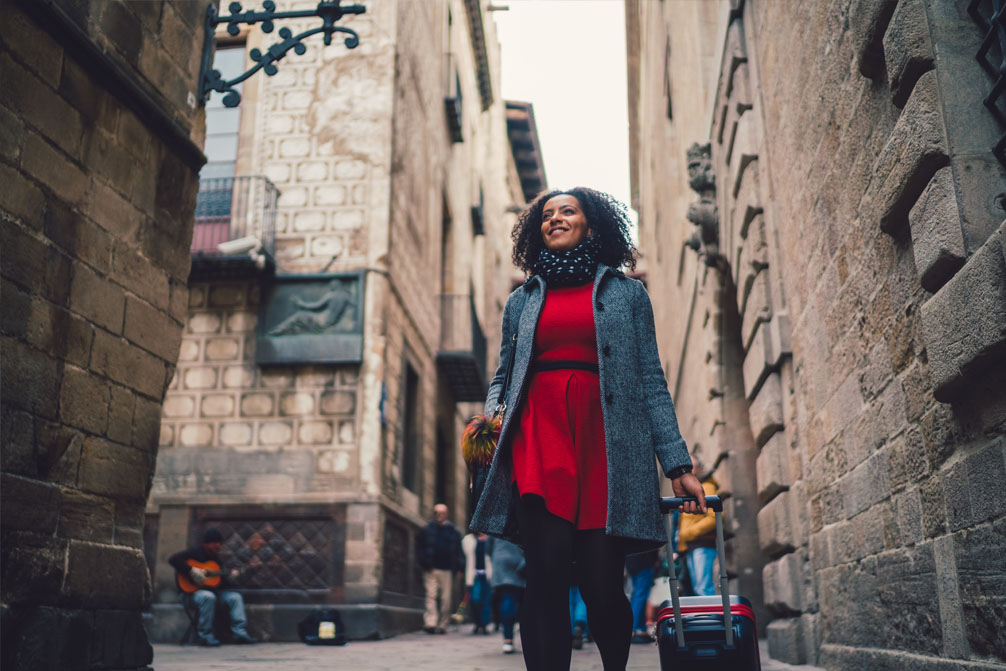 Lady in red dress with a suitcase migrating to Australia